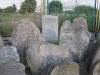 Remnants of old gravestones. At background Faingoild grave